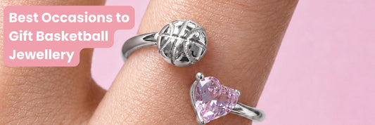 Close-up of a silver basketball ring and pink heart-shaped gemstone ring on a hand, with text reading “Best Occasions to Gift Basketball Jewellery.” Featured image for a basketball gift guide blog.
