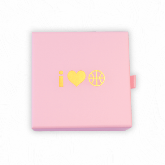Pink jewellery gift box with gold I Heart Hoops basketball logo on the lid