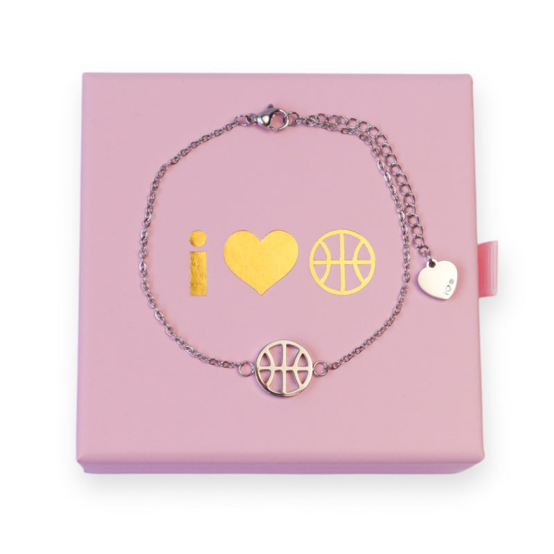 Silver adjustable bracelet with basketball charm and heart charm on the end of the extender chain, displayed on pink I Heart Hoops jewellery box