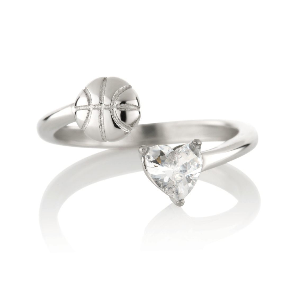 Silver Follow Through basketball ring with clear heart-shaped gemstone and basketball detail on a white background
