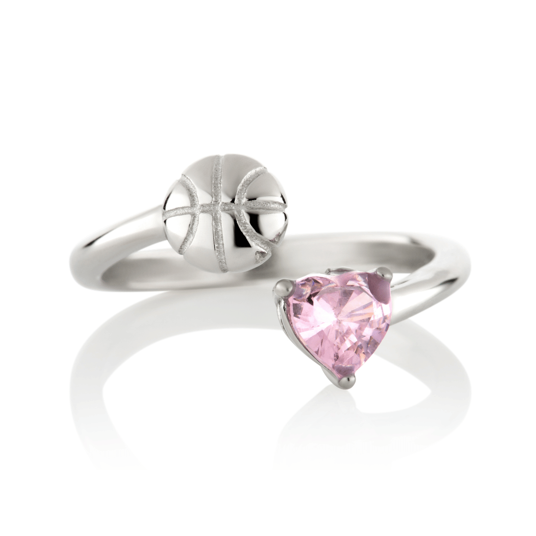 Silver Follow Through basketball ring with pink heart-shaped gemstone and basketball detail on a white background