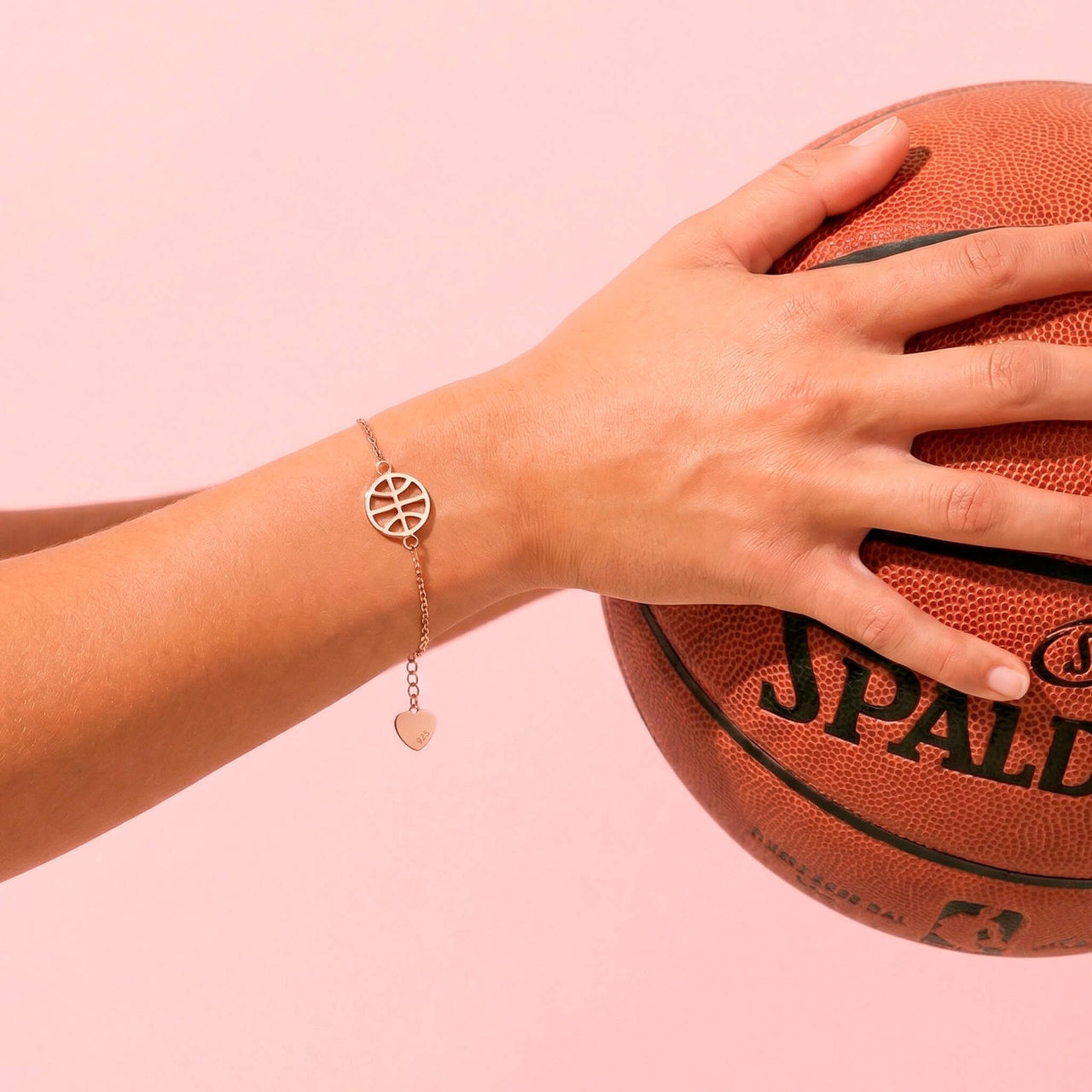 Basketball bracelet worn on a player’s wrist while holding a basketball