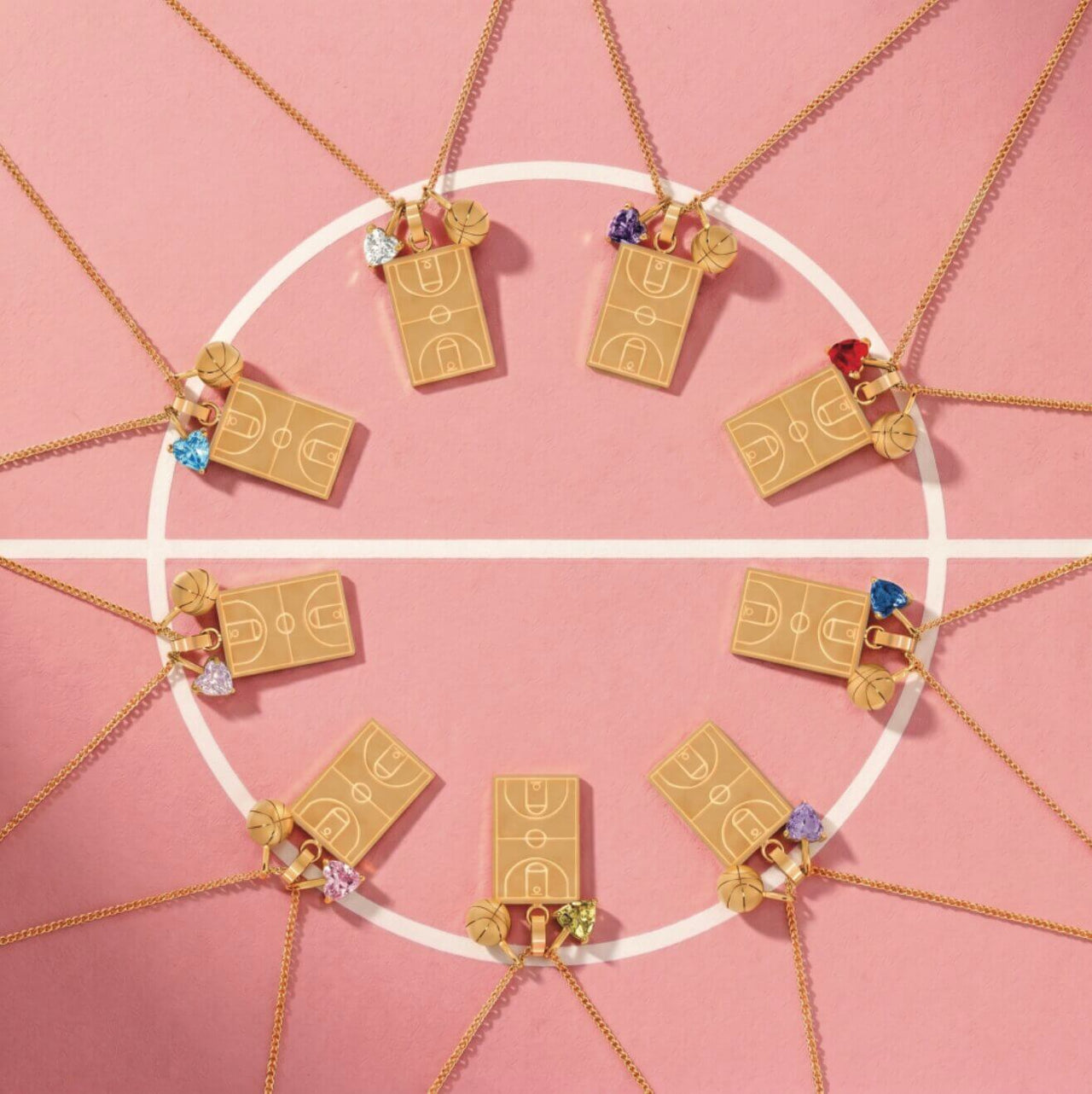 Home Court basketball necklaces with basketball court pendants, basketball charms and colorful heart gem charms displayed on a pink basketball court background